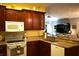Kitchen with wooden cabinets, granite countertops, and white appliances at 2320 Marksmen Ct # 205, Sun City Center, FL 33573