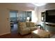 Living room with a view of the screened porch and a couch at 2320 Marksmen Ct # 205, Sun City Center, FL 33573