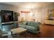 Living room with light teal couches, hardwood floors, and built-in entertainment center at 2320 Marksmen Ct # 205, Sun City Center, FL 33573