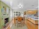 Cozy dining area with a fireplace and wood floors at 240 Timberlane Dr, Palm Harbor, FL 34683