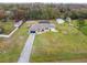 Aerial view of a single-Gathering home with a pool and large yard at 25555 Oaks Blvd, Land O Lakes, FL 34639