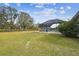 Large grassy backyard with pool and trees at 25555 Oaks Blvd, Land O Lakes, FL 34639