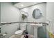 Small bathroom with pedestal sink, toilet, and decorative tile at 25555 Oaks Blvd, Land O Lakes, FL 34639