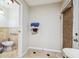 Small bathroom with toilet, bidet, and access to another room at 25555 Oaks Blvd, Land O Lakes, FL 34639