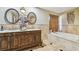 Elegant bathroom with double vanity, soaking tub, and shower at 25555 Oaks Blvd, Land O Lakes, FL 34639