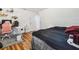 Bedroom with a queen bed, workspace, and wood-look flooring at 25555 Oaks Blvd, Land O Lakes, FL 34639
