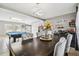 Open dining room with pool table and coffee bar at 25555 Oaks Blvd, Land O Lakes, FL 34639