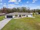 Single story house with a large yard and attached garage at 25555 Oaks Blvd, Land O Lakes, FL 34639