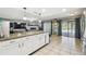 Kitchen with granite counters, white cabinets, and pool view at 25555 Oaks Blvd, Land O Lakes, FL 34639
