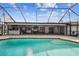 Inviting screened pool and patio with a bar at 25555 Oaks Blvd, Land O Lakes, FL 34639