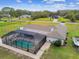 Enclosed pool with a large patio and screened enclosure at 25555 Oaks Blvd, Land O Lakes, FL 34639