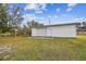 White metal workshop with roll-up door at 25555 Oaks Blvd, Land O Lakes, FL 34639