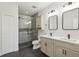 Modern bathroom with double sinks, quartz countertops, and frameless shower at 29857 Southwell Ln, Wesley Chapel, FL 33543