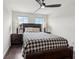 Comfortable bedroom with wood floors, ceiling fan, and ample natural light at 29857 Southwell Ln, Wesley Chapel, FL 33543