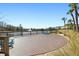 Circular community deck with turquoise chairs overlooking pond at 29857 Southwell Ln, Wesley Chapel, FL 33543