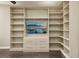 Built-in shelving and drawers with large TV at 29857 Southwell Ln, Wesley Chapel, FL 33543