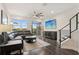 Living room with sectional sofa, dark wood floors, and view to backyard at 29857 Southwell Ln, Wesley Chapel, FL 33543