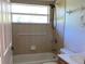 Clean bathroom, bathtub, shower, and tile at 3447 Loveland Blvd, Port Charlotte, FL 33980