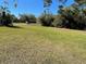 Spacious grassy yard with lush landscaping at 3447 Loveland Blvd, Port Charlotte, FL 33980