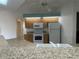 Kitchen with light wood cabinets, granite counters, and white appliances at 3447 Loveland Blvd, Port Charlotte, FL 33980