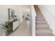 Bright and spacious foyer with staircase and view to dining area at 3467 Hilltop Cir, Lakewood Ranch, FL 34211