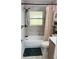 Clean bathroom with a bathtub, shower, and updated tile flooring and shower fixtures at 3628 Dellefield St, New Port Richey, FL 34655