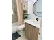 Modern bathroom boasts wood vanity, updated toilet and flooring, and a stylish design at 3628 Dellefield St, New Port Richey, FL 34655