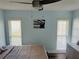 Main bedroom with ceiling fan and large windows at 3628 Dellefield St, New Port Richey, FL 34655