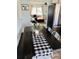 Farmhouse-style dining area with dark wood table and black and white checkered table runner at 3628 Dellefield St, New Port Richey, FL 34655