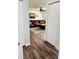 Light and bright hallway with wood-look flooring leading to living room at 3628 Dellefield St, New Port Richey, FL 34655