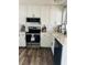 Modern white kitchen with stainless steel appliances and quartz countertops at 3628 Dellefield St, New Port Richey, FL 34655