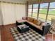 Relaxing sunroom features a sectional sofa and charming decor at 3628 Dellefield St, New Port Richey, FL 34655
