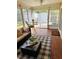 Cozy sunroom with wicker furniture, a coffee table and a view of the backyard at 3628 Dellefield St, New Port Richey, FL 34655