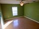 Bedroom with wood floors, ceiling fan, and window at 37733 Dunbar Ave, Zephyrhills, FL 33542