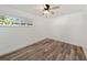 Bright bedroom with wood-look floors and ceiling fan at 3946 Doral Dr, Tampa, FL 33634