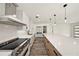 Modern kitchen with white cabinets, stainless steel appliances, and quartz countertops at 3946 Doral Dr, Tampa, FL 33634
