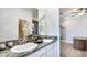 Double vanity bathroom with granite countertop and modern fixtures at 4318 Pullet Ct, Lakewood Ranch, FL 34211