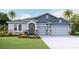 Curb appeal abounds in this beautiful two-story home featuring stone and blue siding at 4318 Pullet Ct, Lakewood Ranch, FL 34211