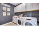 Bright laundry room with Whirlpool appliances and ample cabinetry at 4318 Pullet Ct, Lakewood Ranch, FL 34211