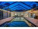 Enclosed pool and spa area beautifully lit at night at 4919 Turtle Creek Trl, Oldsmar, FL 34677