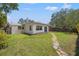 Charming home with a spacious backyard, stone path, and covered patio at 5500 Denver Ne St, St Petersburg, FL 33703