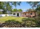House with a large backyard, patio with pergola, and lush lawn at 5500 Denver Ne St, St Petersburg, FL 33703