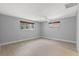 Bright bedroom with light gray walls, wood-look flooring, and large window at 5500 Denver Ne St, St Petersburg, FL 33703