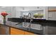 Kitchen sink and countertop with view into living area at 5500 Denver Ne St, St Petersburg, FL 33703