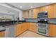 Modern kitchen with light wood cabinets and black countertops at 5500 Denver Ne St, St Petersburg, FL 33703
