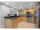 Modern kitchen with light wood cabinets and black countertops at 5500 Denver Ne St, St Petersburg, FL 33703