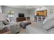 Living room with gray sofas and a view of the kitchen at 5500 Denver Ne St, St Petersburg, FL 33703