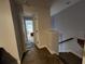 Upstairs hallway with carpet and neutral colored walls leading to bedrooms and stairs at 5514 Viola Lee Way, Lutz, FL 33558