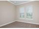 Bright bedroom with neutral walls, carpet, and two windows with blinds at 5531 Orsello St, Palmetto, FL 34221