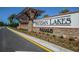 Artisan Lakes entrance with stone and wood accents at 5531 Orsello St, Palmetto, FL 34221
